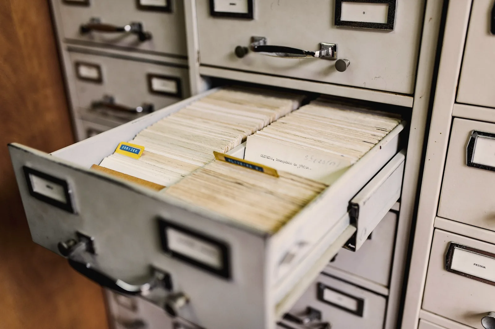 An open card-catalog drawer full of index cards
