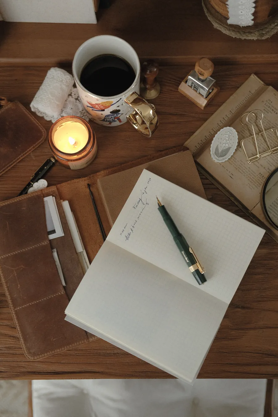 An open notebook and a fountain pen on a desk